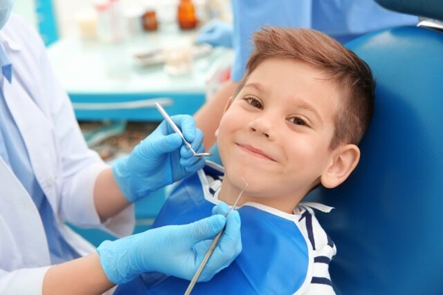 Child smiling in dental chair