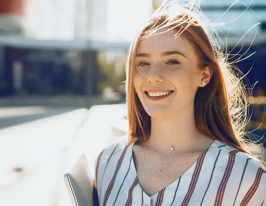 Young woman smiling outdoors